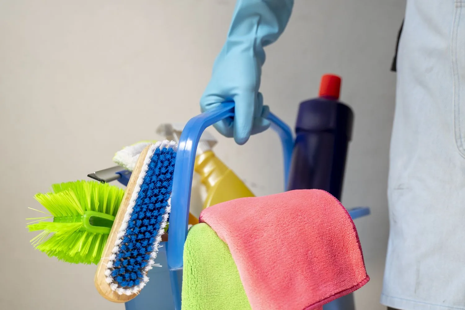 Cleaner deep cleaning behind kitchen appliances during a thorough clean